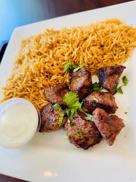 Lamb kabob skewers served with rice and salad