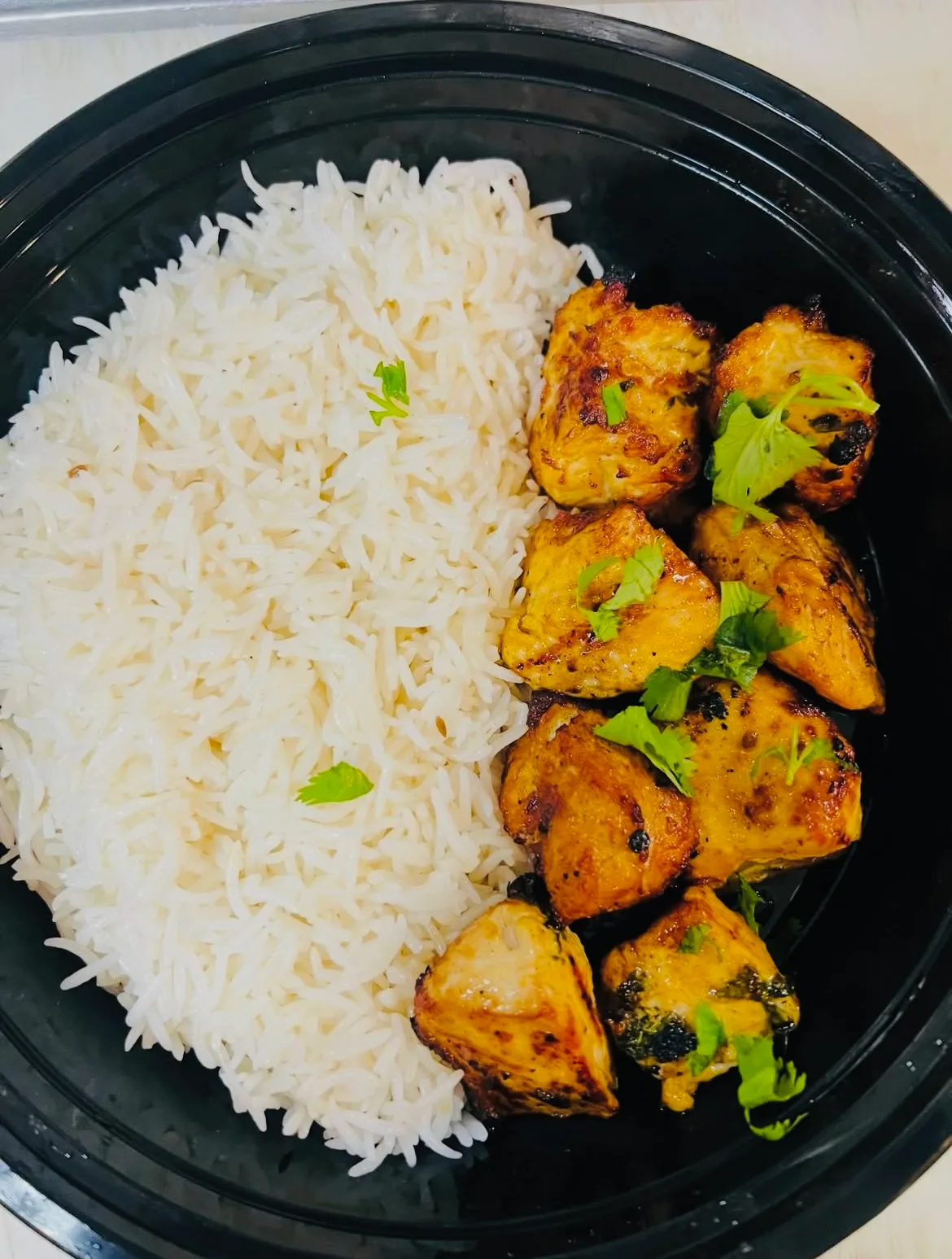 Flame-grilled chicken kabob served with rice