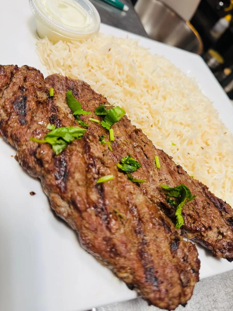 Lamb Shami Kabob on a plate with rice and salad