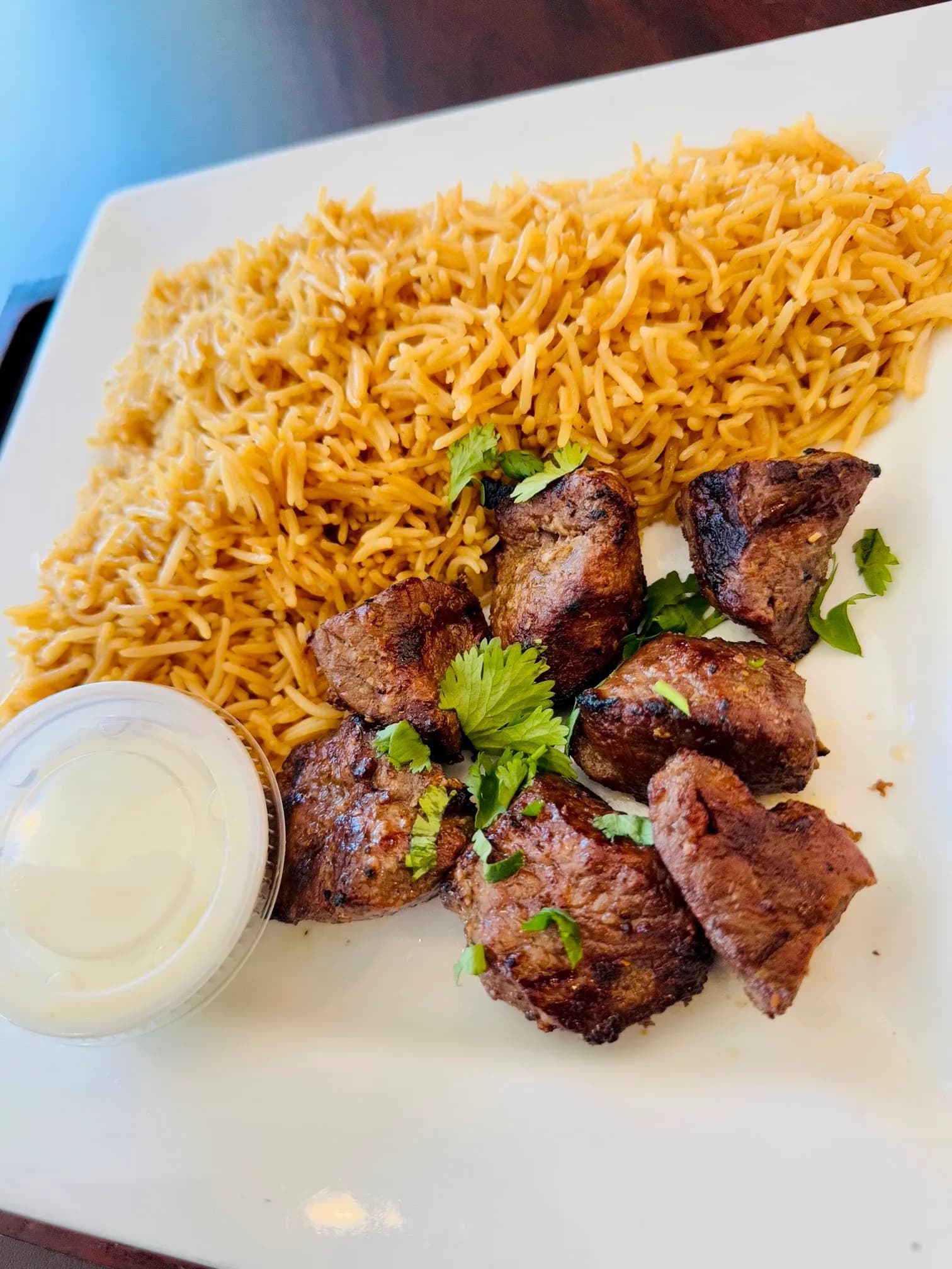Lamb kabob skewers served with rice and salad